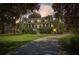Charming two-story home featuring a welcoming front porch and a long driveway amidst lush landscaping at 5010 Timber Race Crse, Hollywood, SC 29449