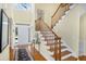 Bright foyer with hardwood floors, a staircase, and a front door at 5010 Timber Race Crse, Hollywood, SC 29449