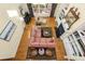 Aerial view of the living room with large pink couch, chairs, and fireplace at 5010 Timber Race Crse, Hollywood, SC 29449