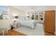 Inviting bedroom with a ceiling fan, hardwood floors, and large window with a backyard view at 5010 Timber Race Crse, Hollywood, SC 29449