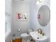 Stylish powder room with modern fixtures, oval mirror, and soft, neutral color scheme at 5010 Timber Race Crse, Hollywood, SC 29449