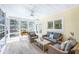 Sunroom with comfortable seating, ceiling fan, and bright windows for enjoying the outdoors at 5010 Timber Race Crse, Hollywood, SC 29449