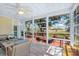 Cozy sunroom with tiled floors, ceiling fan, and large windows offering scenic backyard views at 5010 Timber Race Crse, Hollywood, SC 29449