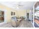 Bright sunroom with comfortable seating, tiled floors, and access to the backyard deck at 5010 Timber Race Crse, Hollywood, SC 29449