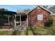 View of backyard with screened porch, patio furniture, and lush green lawn at 503 Amberjack Way, Summerville, SC 29485