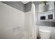 Shower-tub combination with toilet in a bathroom with gray and white walls at 503 Amberjack Way, Summerville, SC 29485
