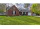 Charming brick home boasts a lush green lawn and solar panels for energy efficiency at 503 Amberjack Way, Summerville, SC 29485