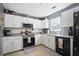 Well-lit kitchen with white cabinetry, modern appliances, and tile backsplash at 503 Amberjack Way, Summerville, SC 29485