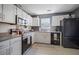 Well-lit kitchen features white cabinets, appliances, gray countertops, and tile backsplash at 503 Amberjack Way, Summerville, SC 29485