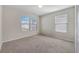 Neutral bedroom with carpet, three windows, and off-white walls at 509 Purple Finch Rd, Summerville, SC 29486