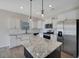 Bright kitchen with granite countertops, stainless steel appliances, and a kitchen island at 509 Purple Finch Rd, Summerville, SC 29486