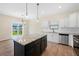 Modern kitchen boasts granite countertops, stainless steel appliances, and views of backyard pond at 509 Purple Finch Rd, Summerville, SC 29486
