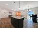 Open concept living area with a kitchen island and lots of natural light from the sliding glass door at 509 Purple Finch Rd, Summerville, SC 29486