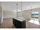 Open-concept living space flows into a modern kitchen with stainless appliances and pond views at 509 Purple Finch Rd, Summerville, SC 29486