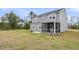 Backyard with a large screened in porch, chairs and mature trees at 5115 Cranesbill Way, Johns Island, SC 29455