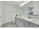 Clean bathroom with gray double sink vanity, large mirror, and shower at 5115 Cranesbill Way, Johns Island, SC 29455