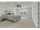 Spacious primary bedroom with a ceiling fan, neutral walls, and large windows at 5115 Cranesbill Way, Johns Island, SC 29455