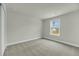 Empty bedroom featuring neutral paint and carpet and filled with natural light at 5115 Cranesbill Way, Johns Island, SC 29455