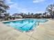 Resort-style community pool featuring clear blue water, ample lounge chairs, and a charming bathhouse at 5115 Cranesbill Way, Johns Island, SC 29455