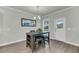 Cozy dining area with a gray table and seating for four, next to an exterior door at 5115 Cranesbill Way, Johns Island, SC 29455