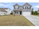 Charming two-story home featuring gray siding, black shutters and a two-car garage at 5115 Cranesbill Way, Johns Island, SC 29455