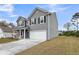 Charming two-story home featuring gray siding, black shutters and a two-car garage at 5115 Cranesbill Way, Johns Island, SC 29455