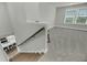 Bright stairway landing with neutral carpet, wood railing and staircase at 5115 Cranesbill Way, Johns Island, SC 29455