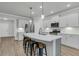 Modern kitchen with white cabinets, quartz countertops, stainless steel appliances, and island with seating at 5115 Cranesbill Way, Johns Island, SC 29455
