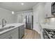 Spacious kitchen features stainless steel refrigerator, modern appliances, and an island with a sink at 5115 Cranesbill Way, Johns Island, SC 29455
