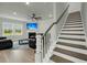 Open concept living room featuring a fireplace, TV, and staircase at 5115 Cranesbill Way, Johns Island, SC 29455