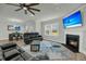 Open concept living room with fireplace, ceiling fan, and view into the dining area at 5115 Cranesbill Way, Johns Island, SC 29455