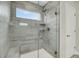 Modern shower featuring gray tiling, a glass door, and a handheld shower head at 5115 Cranesbill Way, Johns Island, SC 29455