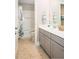 Well-lit bathroom with gray vanity, double sinks, and a separate toilet and shower area at 523 Verdi Dr, Summerville, SC 29486