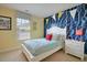 Cozy bedroom with a twin bed, cheerful wall decor, and a bright window at 523 Verdi Dr, Summerville, SC 29486