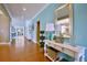 Bright hallway with hardwood floors leads to a living room and is decorated with a white console table at 523 Verdi Dr, Summerville, SC 29486