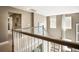 Hallway with wooden banister and tan walls leading to upstairs bedrooms and bathrooms in a two story home at 523 Verdi Dr, Summerville, SC 29486