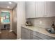 Spacious hallway view into functional home office featuring modern cabinetry, countertops and flooring at 523 Verdi Dr, Summerville, SC 29486