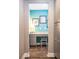 Hallway view of functional home office featuring modern desk area, cabinets and hardwood flooring at 523 Verdi Dr, Summerville, SC 29486