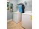 Functional laundry area features a full sized washer and dryer, plus overhead storage shelves at 523 Verdi Dr, Summerville, SC 29486