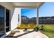 Covered backyard patio with yellow chairs, lush green lawn, and sliding glass door enhance outdoor living at 538 Spanish Wells Rd, Summerville, SC 29486
