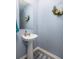 Powder room features a pedestal sink, mirror, and decorative floral wreath at 538 Spanish Wells Rd, Summerville, SC 29486