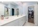 Bright bathroom featuring double sinks with white countertops and a large mirror at 538 Spanish Wells Rd, Summerville, SC 29486