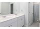 Bathroom with double sinks and white cabinets, plus a shower with a patterned curtain at 538 Spanish Wells Rd, Summerville, SC 29486