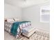 Bright bedroom features a ceiling fan, bright white walls, and a bench at the end of the bed at 538 Spanish Wells Rd, Summerville, SC 29486