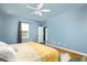 Inviting bedroom features a ceiling fan, light blue walls, and a window with outside views at 538 Spanish Wells Rd, Summerville, SC 29486