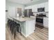 Modern kitchen with a large island, stainless steel appliances, and sleek white cabinetry at 538 Spanish Wells Rd, Summerville, SC 29486