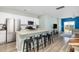 Kitchen and open-concept living area with an island with seating, stainless steel appliances, and a sliding glass door at 538 Spanish Wells Rd, Summerville, SC 29486
