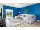 The living room with hardwood floors and a light gray couch has large doors to the back yard at 538 Spanish Wells Rd, Summerville, SC 29486