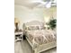 Bedroom featuring a queen-sized bed with a paisley comforter, side table, and a leafy green plant at 572 Tidewater Chase Ln, Summerville, SC 29486