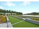 Bocce ball court with lawn and landscaping near the lake, an ideal space for outdoor recreation and relaxation at 572 Tidewater Chase Ln, Summerville, SC 29486